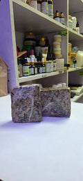 Raw African black soap, commonly used as a natural skin cleanser typically contains natural ingredients like palm oil, plantain ash, and shea butter used to relieve acne, remove blemishes, and cleanse